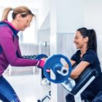 Sneakers and workout gear laid out with a motivational quote: How to get motivated to get fit and healthy