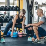 Motivational Fitness Poster Motivational fitness poster: 'Sweat now, shine later' with weightlifters and bright colors