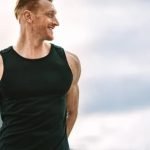 Man bicycling for fitness exercise in the park on a sunny day