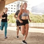 Aerobic Exercises Improve Cardiovascular Fitness A woman jogging on a treadmill, demonstrating how aerobic exercises improve cardiovascular fitness